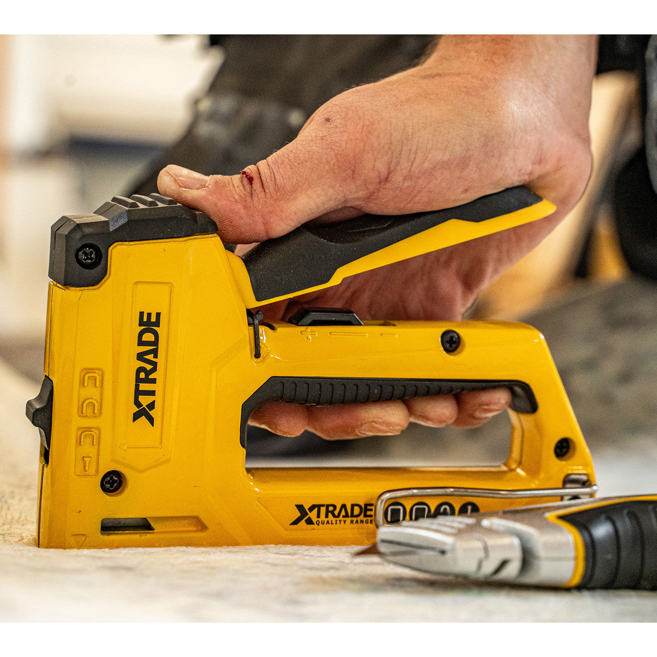 XTrade X0900073 Heavy Duty Staple Gun 4 in 1 being used in flooring application
