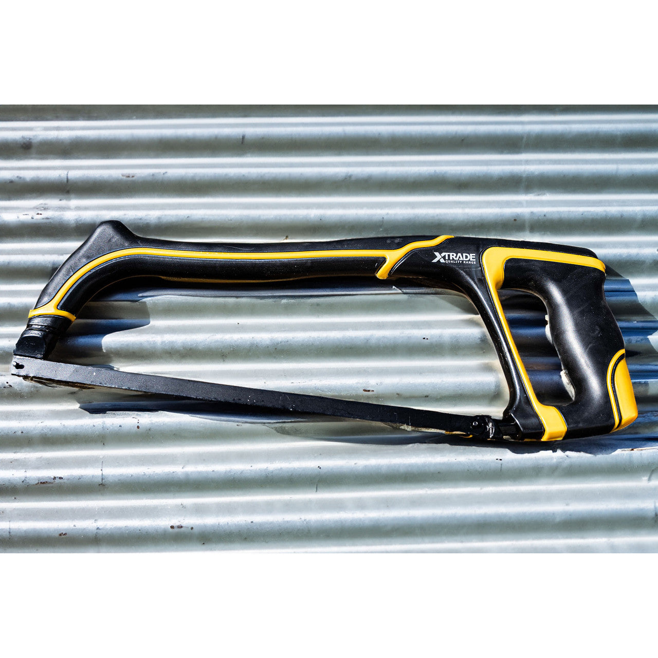 XTrade X0900020 Pro Heavy Duty Hacksaw 300mm (12") pictured on corrugated iron