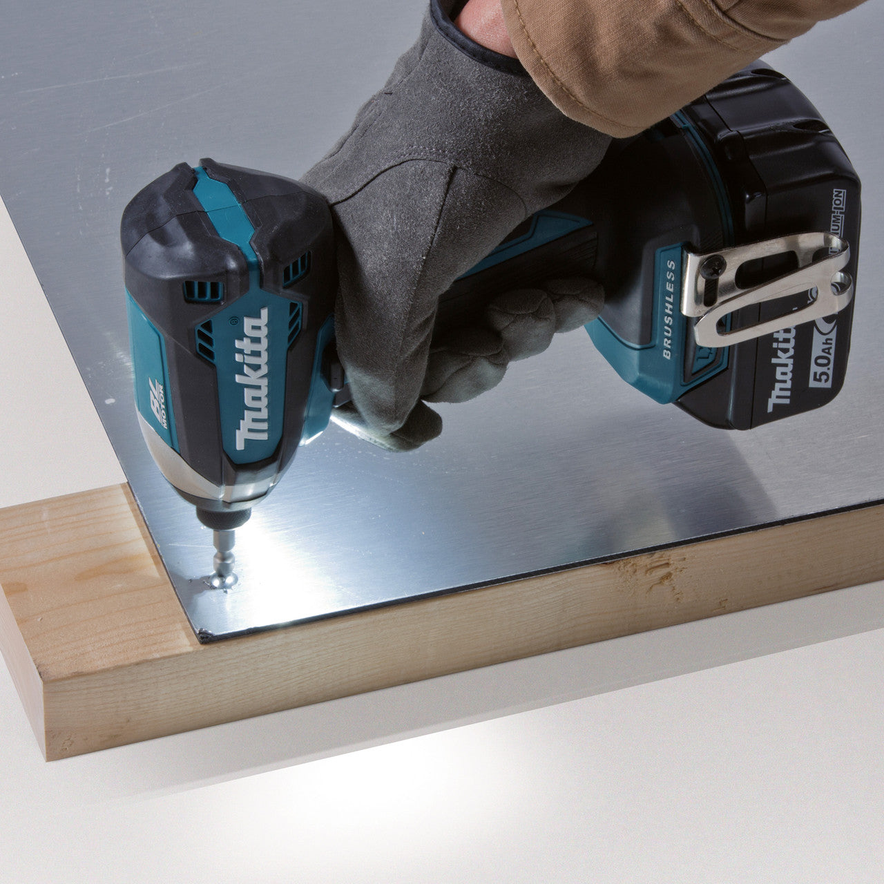 Makita DTD153Z 18V LXT Brushless Impact Driver (Body Only) close up screwing into metal
