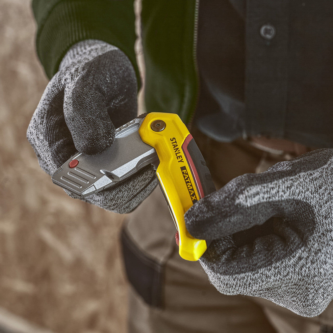 Stanley 0-10-825 FatMax Retractable Folding Knife with 3 Blades in use being folded