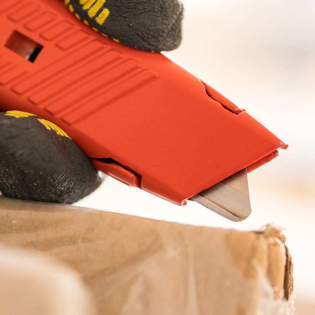 Stanley 0-10-189 Springback Safety Knife in use cutting cardboard
