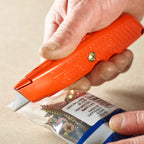 Stanley 0-10-189 Springback Safety Knife in use cutting packaging